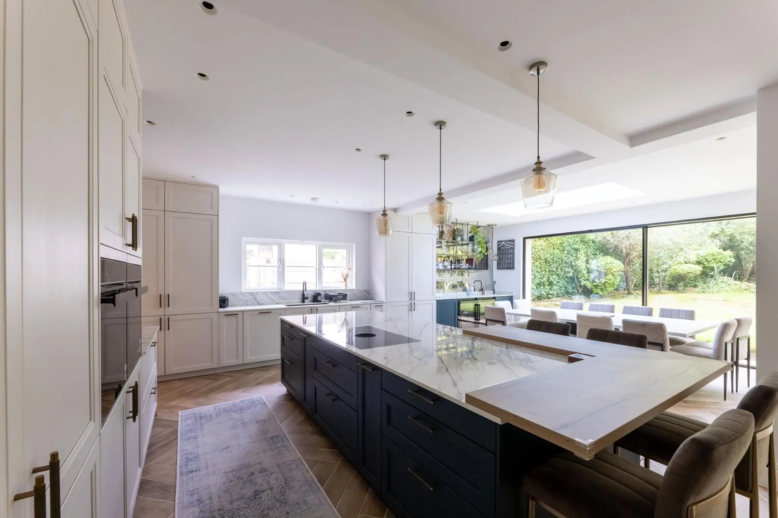 Bespoke kitchen with central island and modern pendants, Hertfordshire