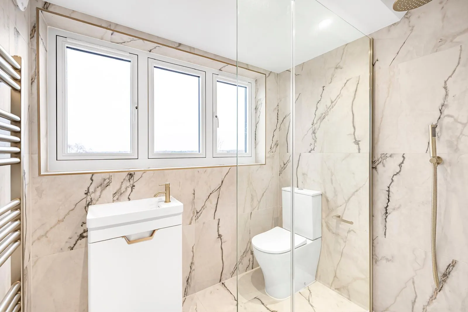 Marble-finished family bathroom, Hertfordshire